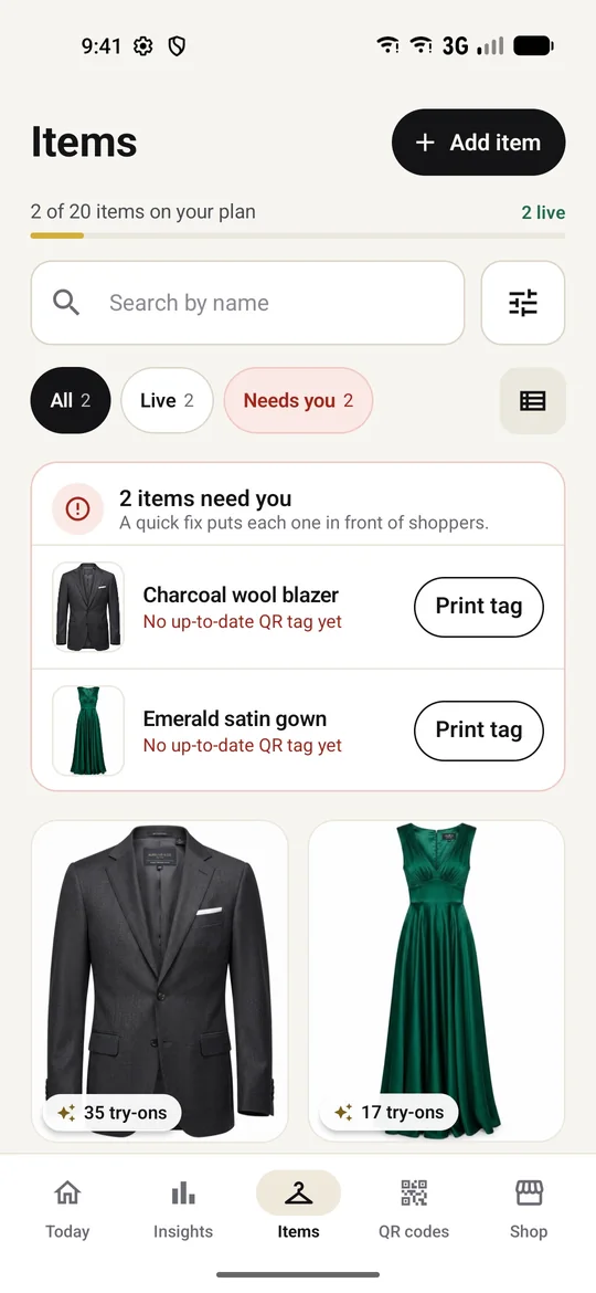 Items grid showing a charcoal blazer and emerald gown with try-on counts